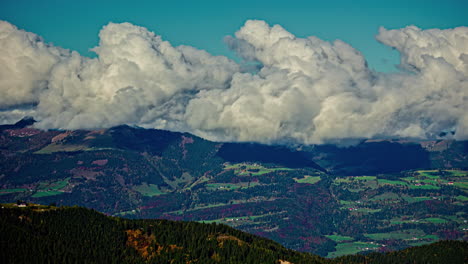 Billowing-clouds-roll-over-vibrant-green-hills-in-a-dynamic-timelapse,-showcasing-nature's-beauty