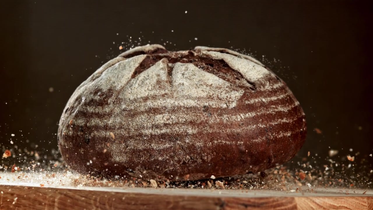 Freshly Baked Sourdough Bread with Falling Crumbs in Slow Motion