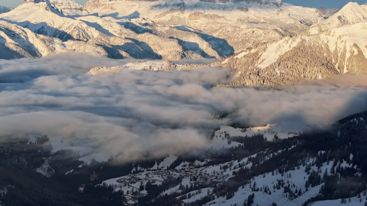Aerial drone view of snow on the mountains in the Dolomites, Italy
