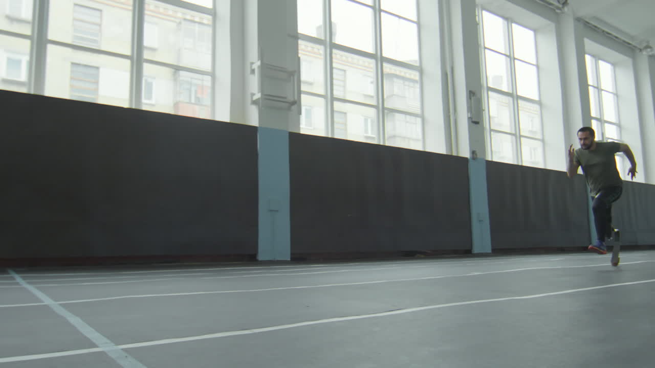 Athlete with Prosthetic Leg Running in Stadium