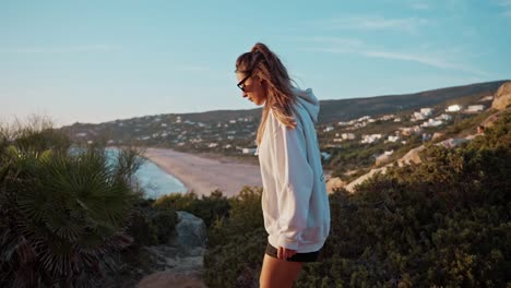 beautiful lady wearing sunglasses walking to enjoy stunning sea landscape