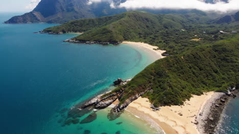 aerial view of a secluded beach with a sailboat