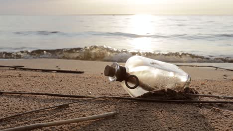 message in the bottle against the sun setting down