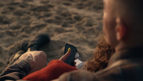 unrecognizable couple enjoying vacation on sandy morning sunrise beach closeup