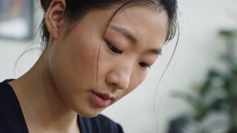 a close-up look at a young woman deeply engaged in creative work, showcasing focus and concentration in a serene environment
