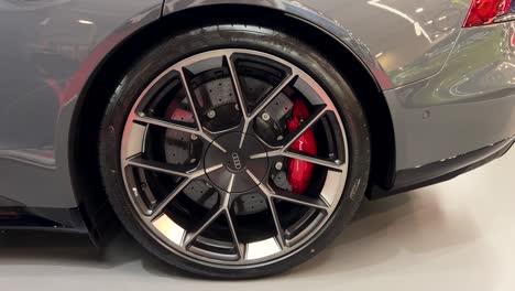close-up of aluminum rim with tire on an audi rs e-tron gt performance. audi red ceramic brake pads. sofia motor show 2024.