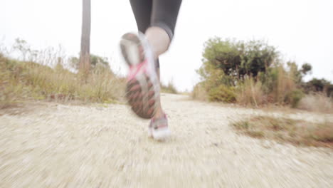 woman running trail close up shoes steadicam shot