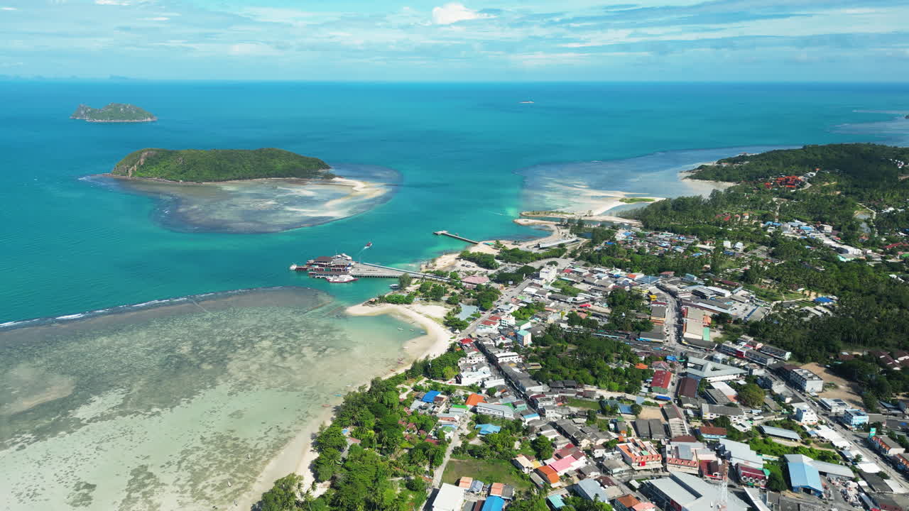 Aerial backwards flight showing Koh Phangan Island during sunny Day, Thailand