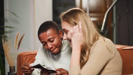 girlfriend with black partner looks at ultrasound pictures