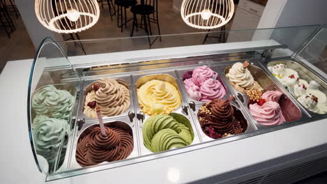 assorted ice cream and gelato flavors in a display case