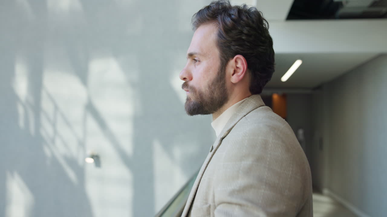 Pensive Businessman Looking Out Window