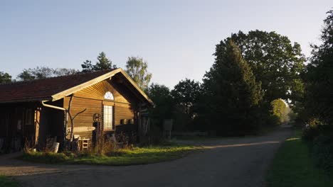 Static-shot-of-rural-wooden-little-house-in-middle-of-countryside-at-sunset
