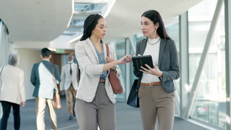 business, women walking and talking with tablet