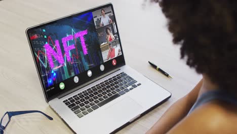 african american businesswoman using laptop for video call with diverse business colleagues