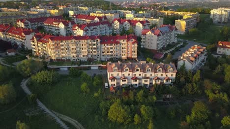 aerial of residential area at sunset with blocks of flats and houses