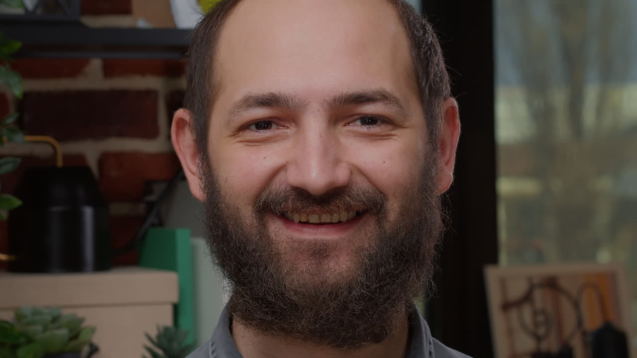 Portrait of caucasian man with unshaved beard smiling in front of camera