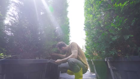 horticulture. a gardener controls the soil by hand.