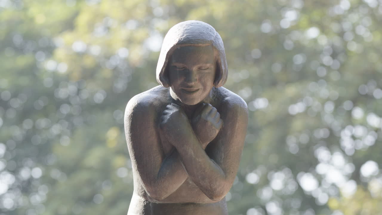 Central frame mid shot of the woman with crossed arms sculpture in Oslo