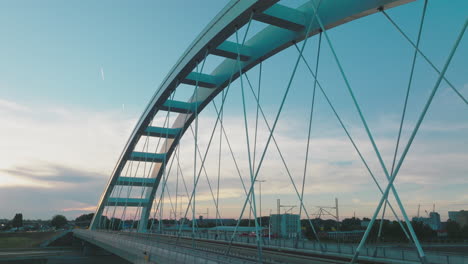 modern arch bridge at sunset