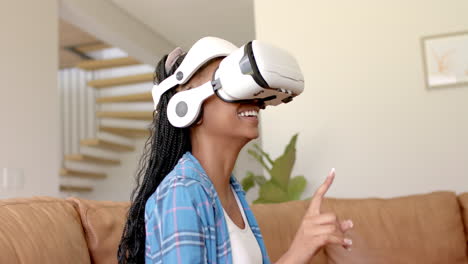 A-young-African-American-woman-wearing-VR-headset,-laughing