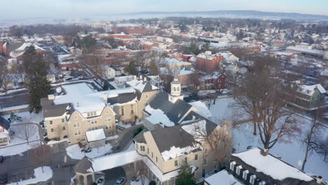 Winter-snow,-snowflakes-on-small-town-and-church-in-USA