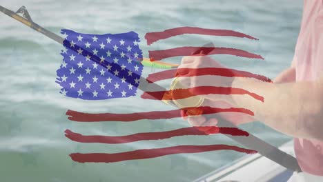 American-flag-design-pattern-against-mid-section-of-caucasian-man-using-fishing-rod-on-a-boat