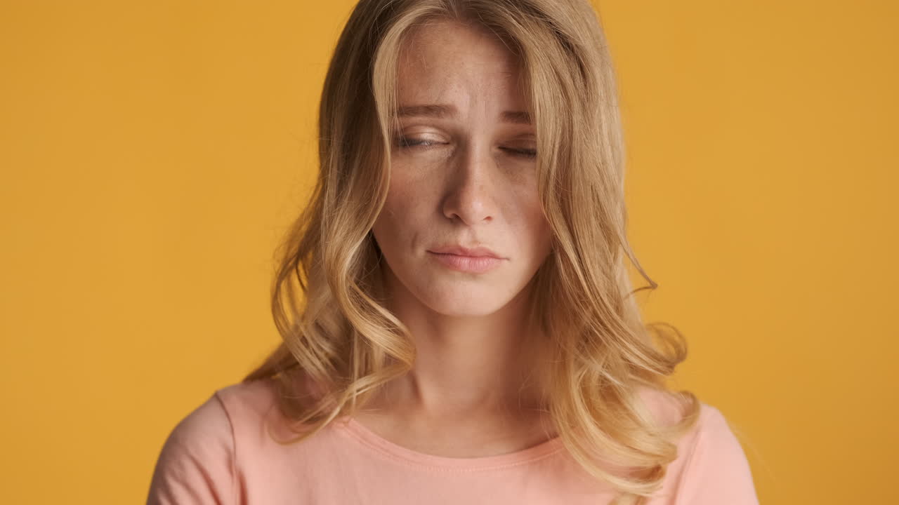 Caucasian woman looking sad on camera.