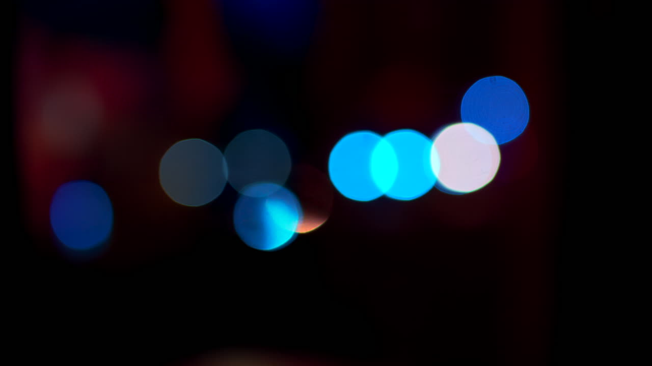 Abstract display of out-of-focus, colourful lights in a dark setting
