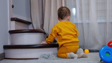 toddler playing near stairs
