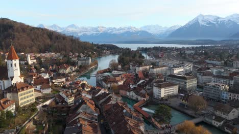 thun town on river aare with lake and alpine mountain landscape beyond