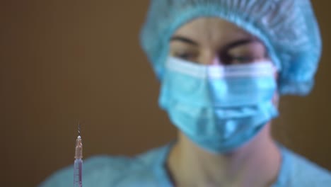 doctor in latex gloves fill in syringe with medicine from glass vial, close up 02