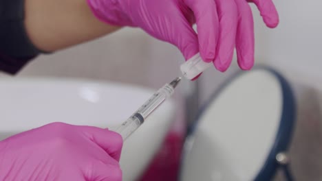 doctor preparing a syringe and needle for an injection