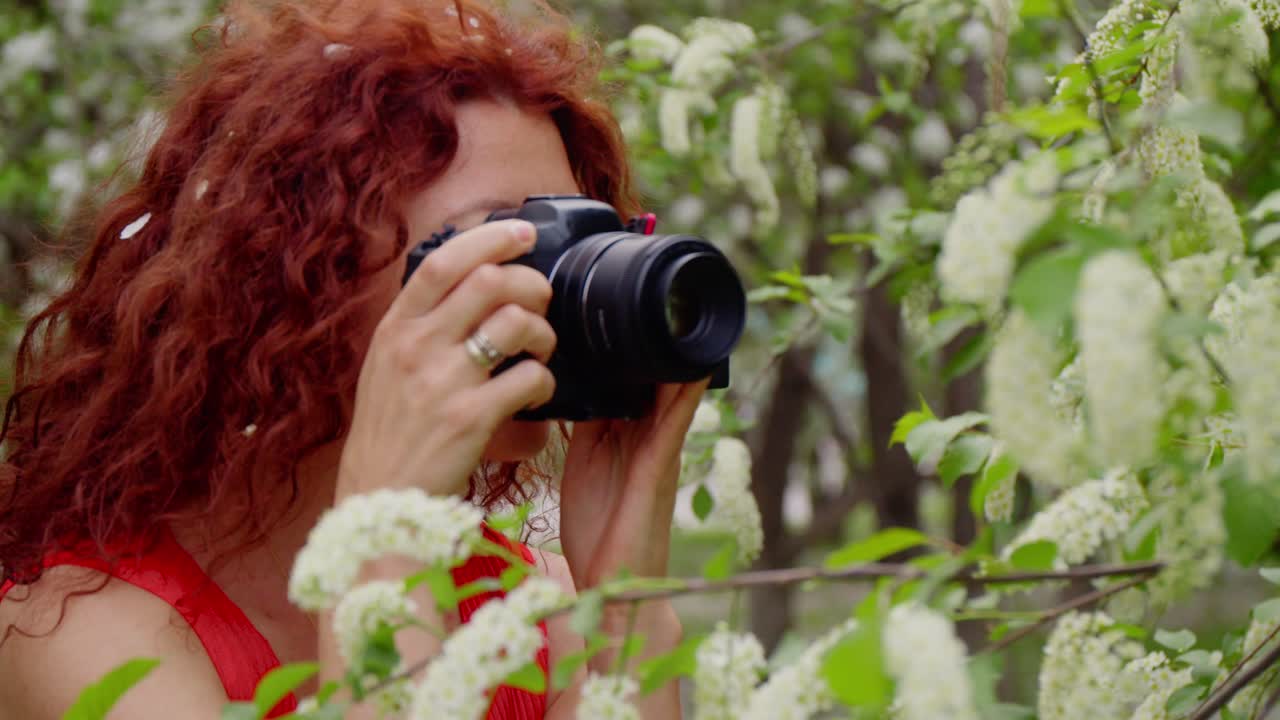 Woman taking photo of spring flowers
