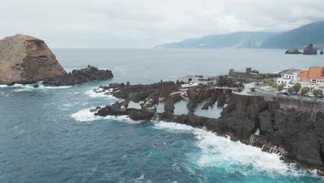 ocean waves crashing against the natural swimming pool near the ilheu mole in porto moniz, portugal