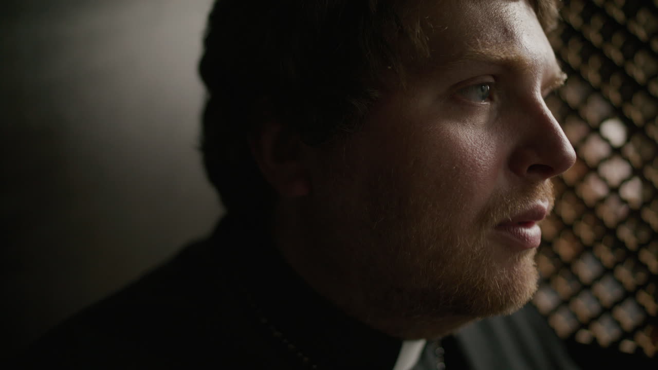 Priest Sitting in Confessional Booth, Giving Advice to Penitent