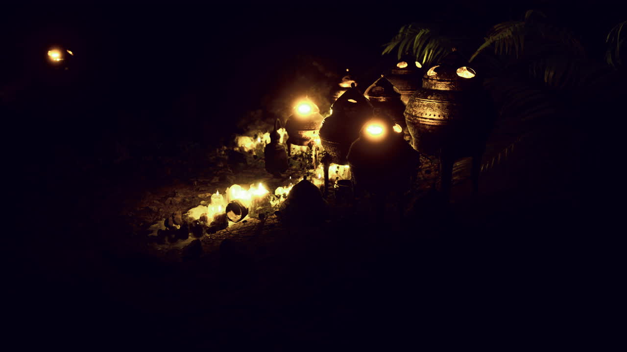 Warm glow of candlelit pottery displayed in a serene outdoor setting at night