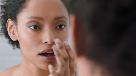 portrait-beautiful-african-american-woman-looking-in-mirror-at-perfect-skin-enjoying-natural-complexion-getting-ready-at-home