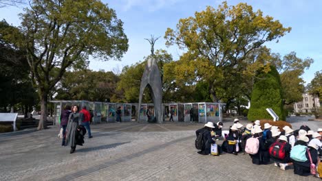 group of students interacting near outdoor artwork