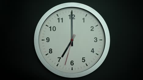 white wall clock tells the time seven o'clock.