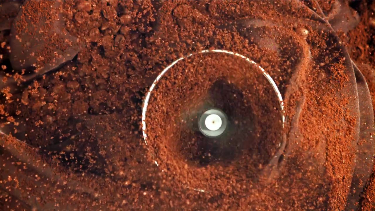 Slow Motion of Coffee Beans Being Ground into Powder