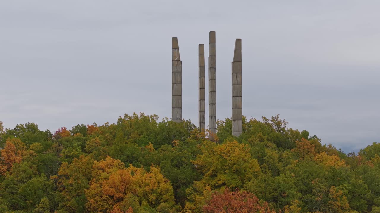Drone orbits Samuil's Fortress in Bulgaria on a rainy autumn day, capturing the monument, wet landscape, and surrounding moody scenery from above