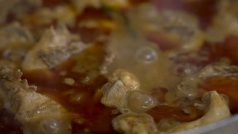 vista de cerca del pollo al curry burbujeante y humeante