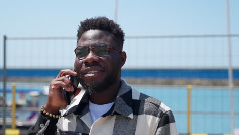 man talking on phone at port