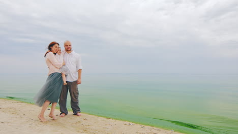 Young-Family-Of-Three-Posing-For-A-Photograph-On-Beach