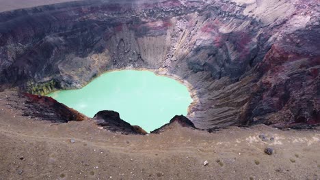 volcano rim aerial reveals boiling, hot lake in deep summit crater