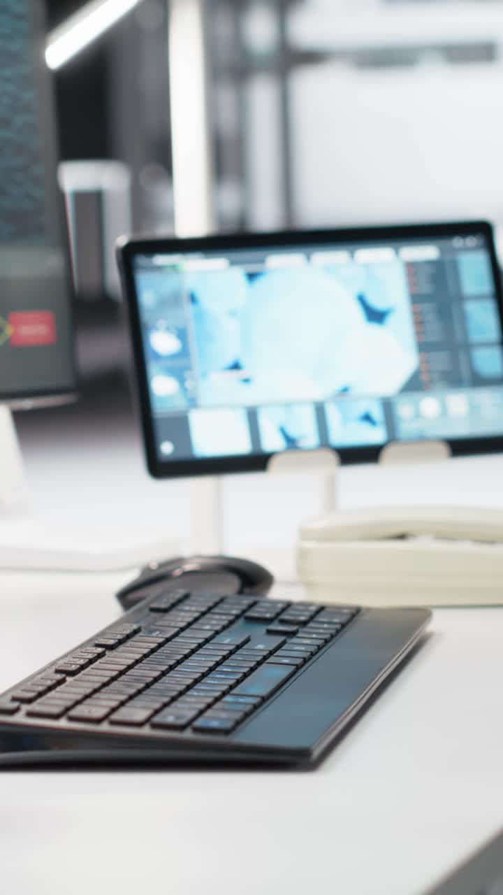 Vertical video Research facility workstation with computer monitor displaying DNA data
