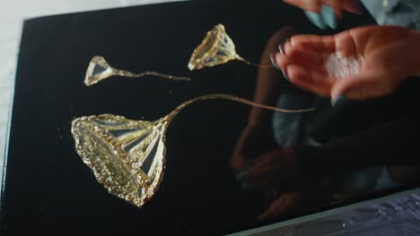 creating resin art with gold leaf and crystals