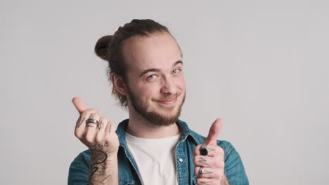 caucasian young man showing money gesture on camera.