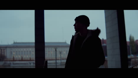 man looking at cityscape in silhouette