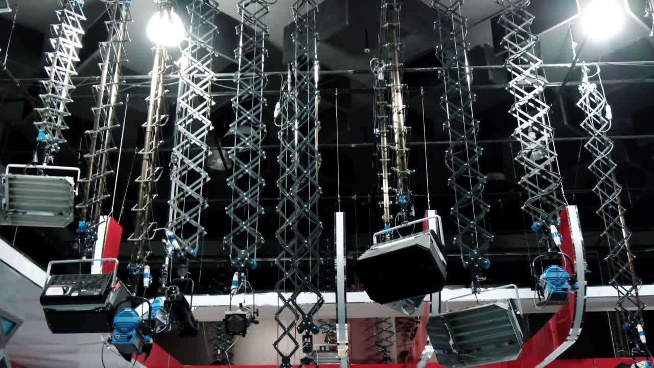 Professional tv station set lights hanging on the ceiling at the studio